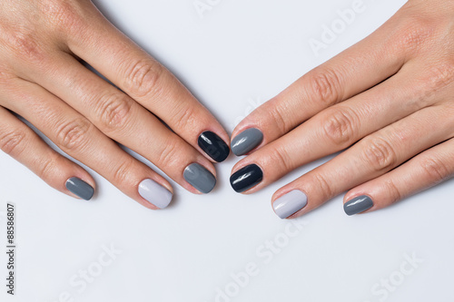 Hand with a stylish gray manicure isolated on white background