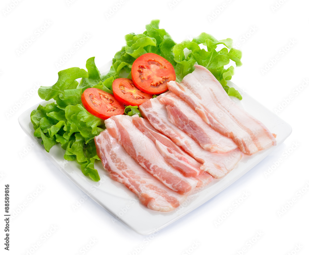 Sliced Bacon with vegetable in the dish on background Sliced Bacon with vegetable in the dish on background