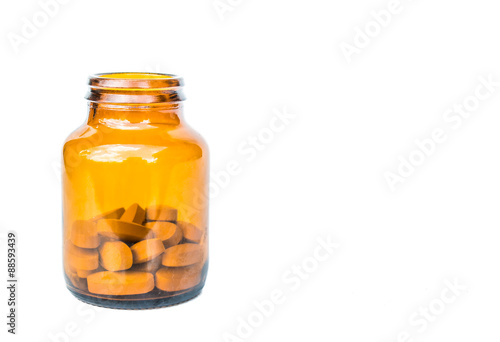 yellow bottle with pills isolated on white background