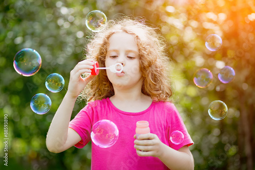 Girl blowing soap bubbles   toning for instagram filter.