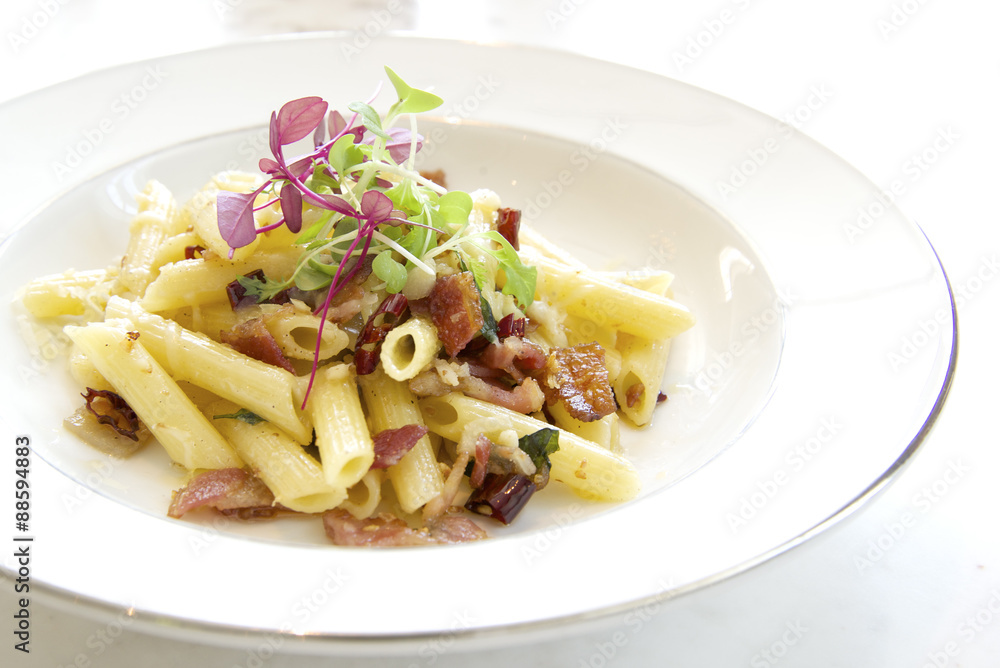 Penne with garlic and oil (aglio e olio) on white plate
