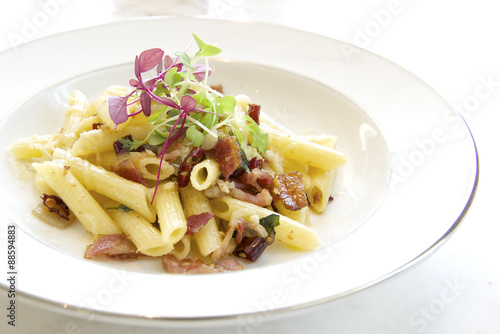 Penne with garlic and oil (aglio e olio) on white plate
