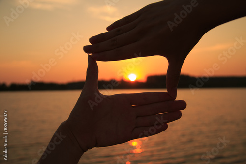 Hand frame against the sunset photo