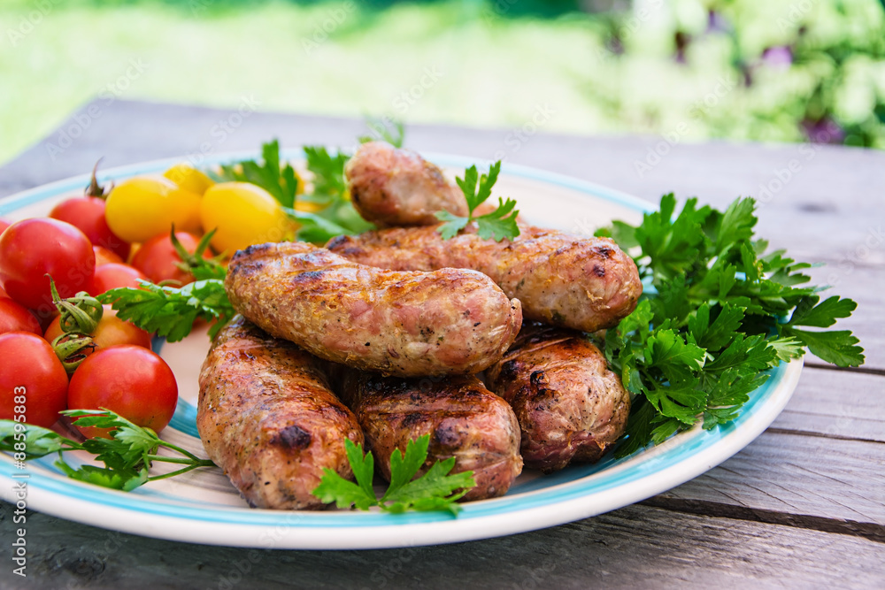 Homemade sausages  with vegetables on the grill