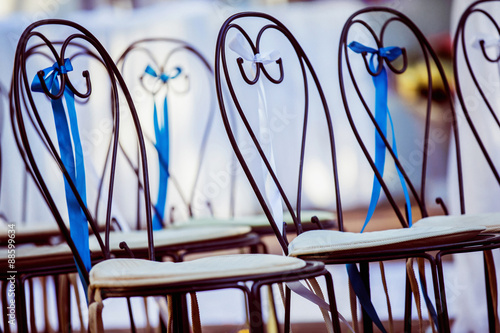 Row of decorated chairs at a wedding ceremony 