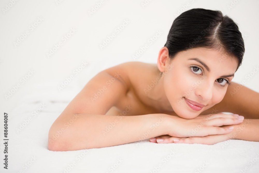 Pretty brunette enjoying a massage smiling at camera Pretty brunette enjoying a massage smiling at camera