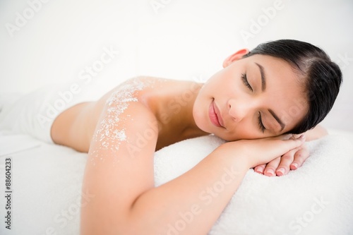 Woman sleeping with salt scrub on the back