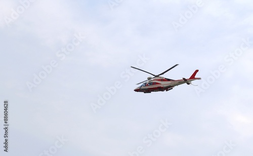big helicopter of fireman flies in the sky during an emergency