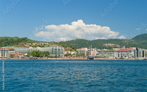 view of beach with hotels and sunbeds from sea