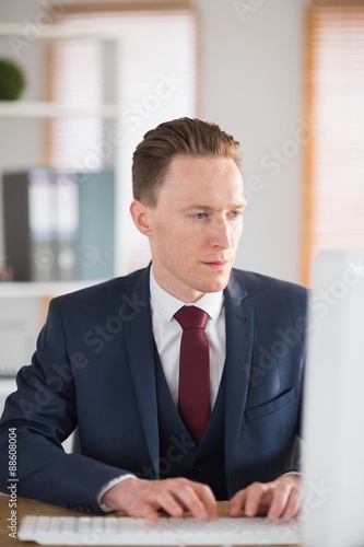 Stylish businessman working at his desk