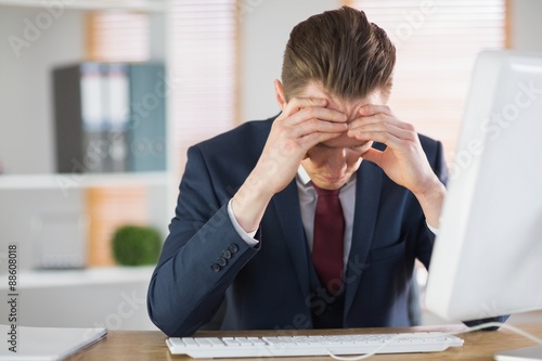 Worried businessman working at his desk