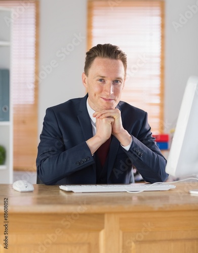 Happy businessman working at his desk 