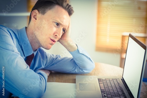 Focused businessman looking at laptop