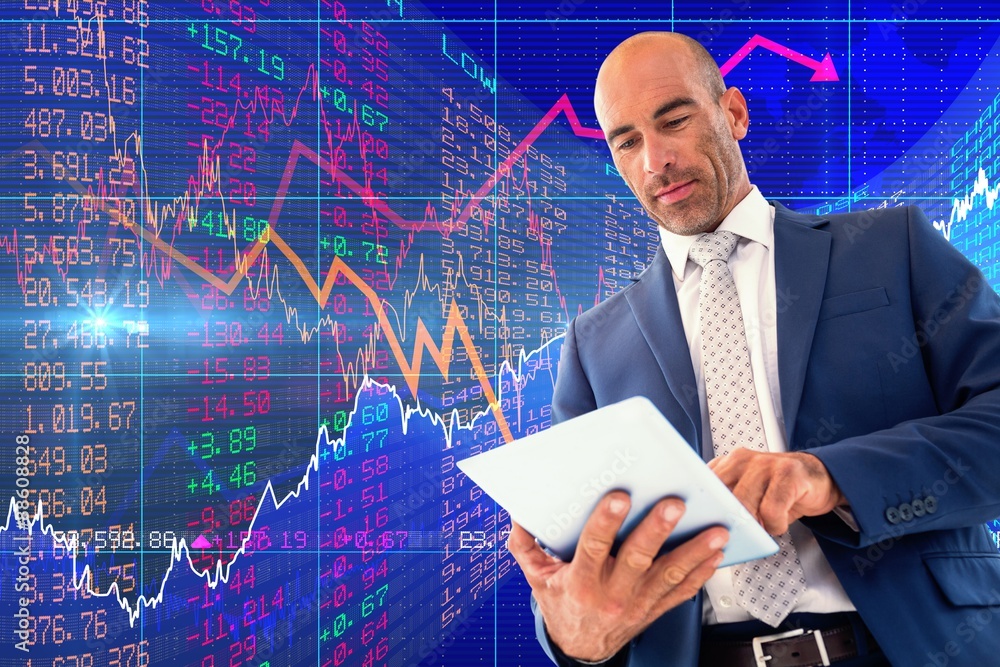Composite image of businessman using a tablet Composite image of businessman using a tablet