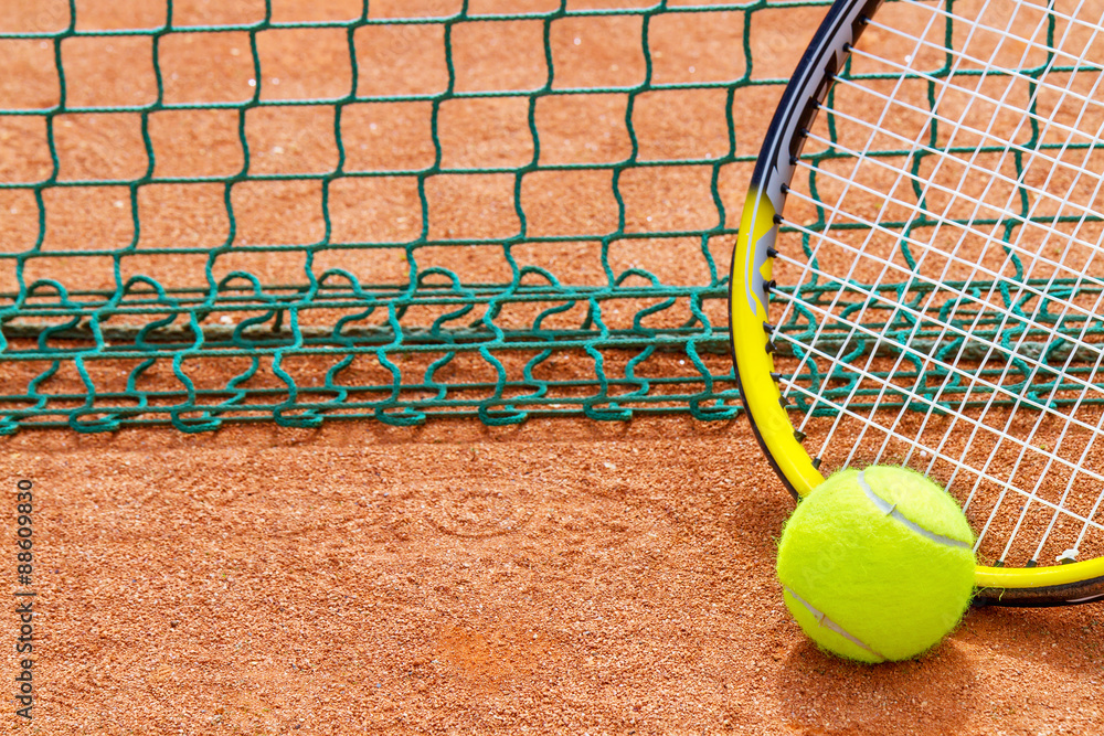 Tennis racket and ball on the court.