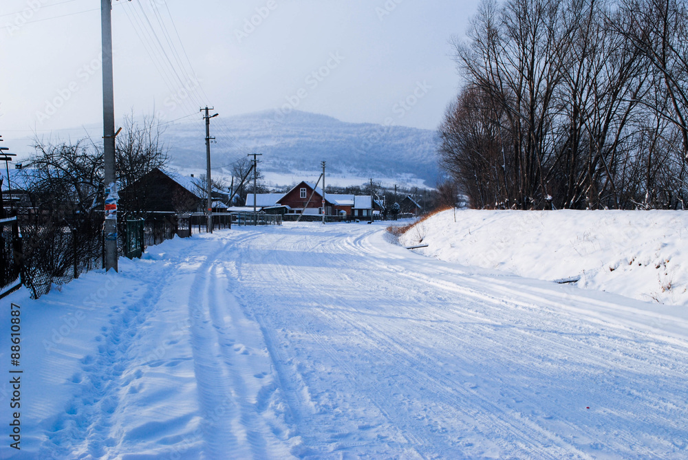 Winter village. Road with snow