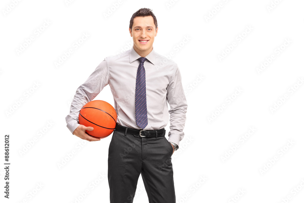 Young businessman holding a basketball