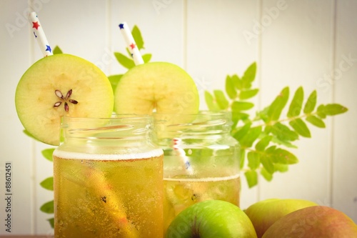 Cider apple juice in glass jars with apples
