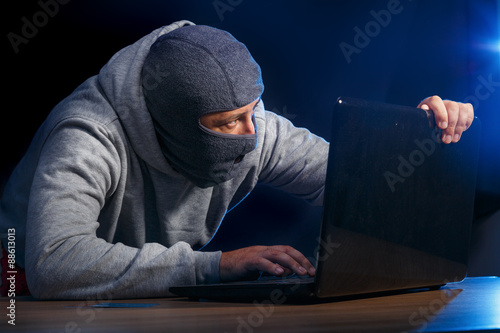 Canvas Print Cyber criminal hacking into a computer. Fear of getting caught