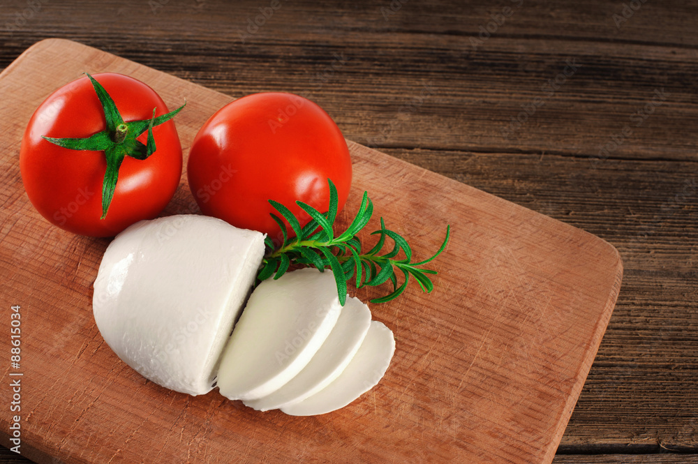 Mozzarella cheese with tomatoes and rosemary. Mozzarella cheese with tomatoes and rosemary.