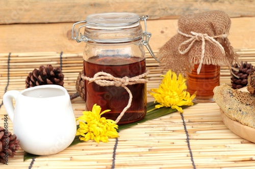 Honey variety with honeycomb and honey in a jar with beeswax.
