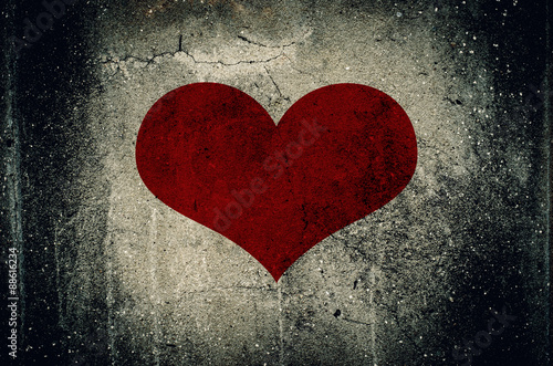 Red heart painted on grunge cement wall background