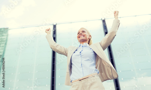 young smiling businesswoman over office building