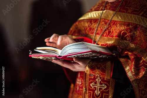 Fotografie Closeup of orthodox priest's hands holding the Bible