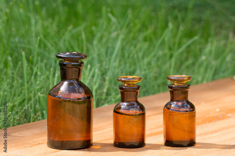 little brown bottles on booden board and grass