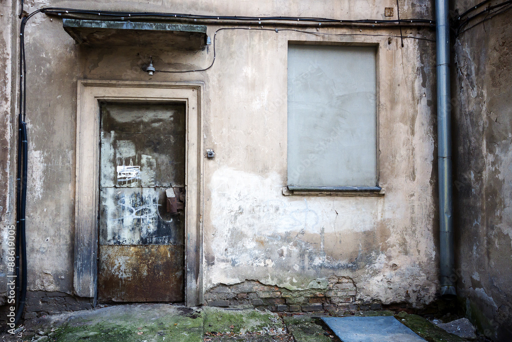 Boarded up window and rusty door Boarded up window and rusty door