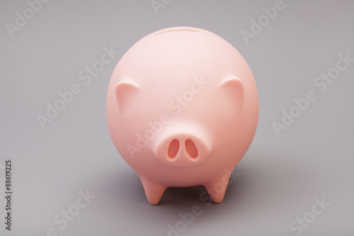 Piggy bank over gray background