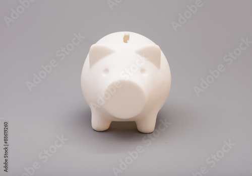 Piggy bank over gray background