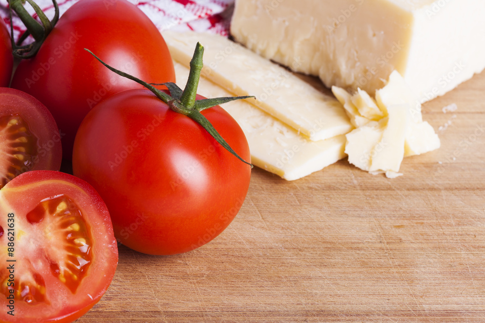 Tomatoes and cheese on chopping board Tomatoes and cheese on chopping board
