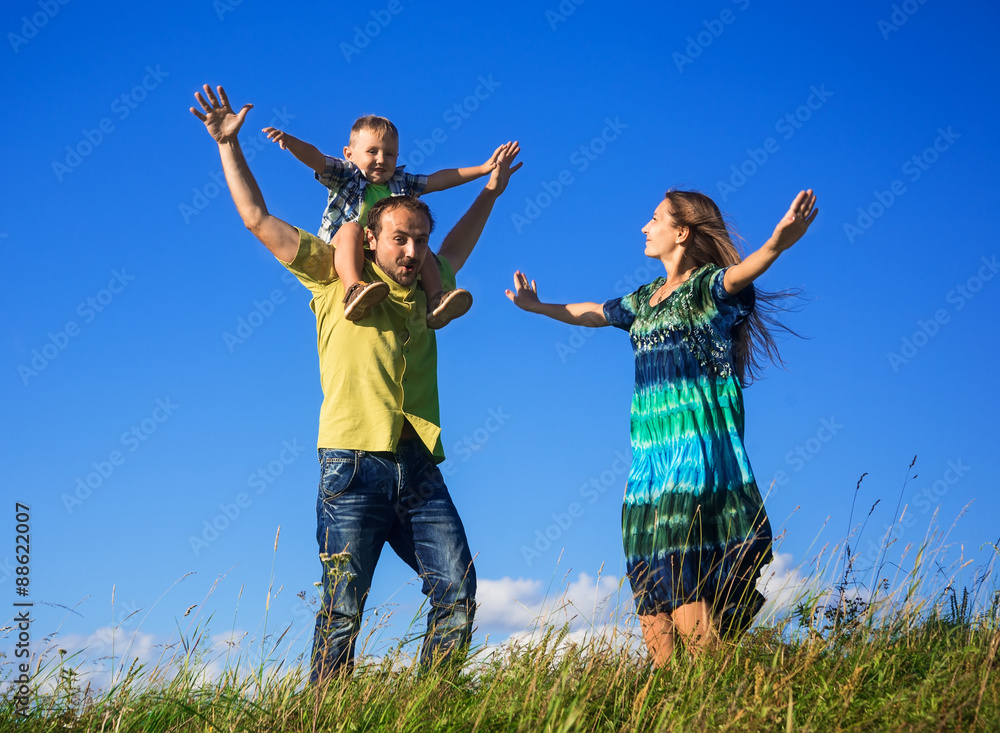 Happy family from three people have fun outdoors