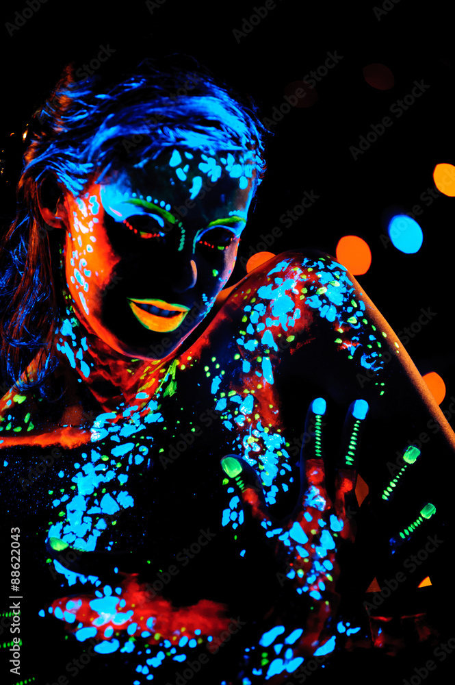 Girl with neon paint bodyart portrait, studio shot