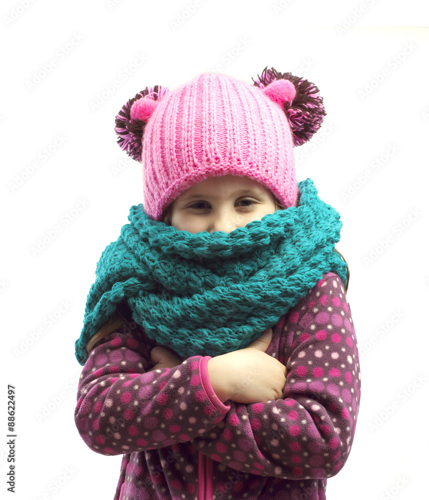 Portrait of a girl in a cap and scarf . Isolated background. Portrait of a girl in a cap and scarf . Isolated background.