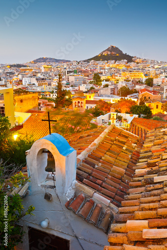 View of Lycabettus hill and a small Greek orthodox church in Anafiotika, Athens. photo