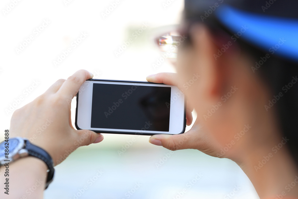 closeup of young woman hands use smart phone in city