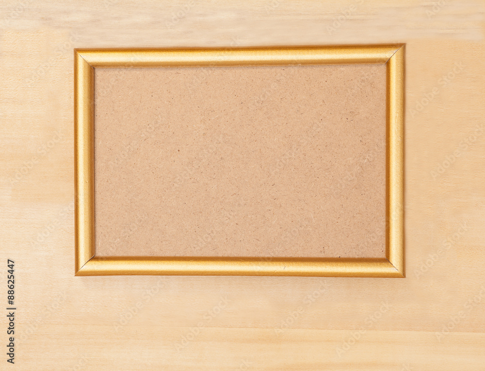 Empty golden picture frame on wooden background Empty golden picture frame on wooden background