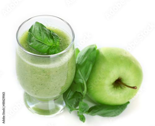 Glass of green healthy juice with basil and apple isolated on white