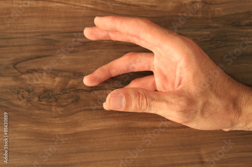 hand on wooden background