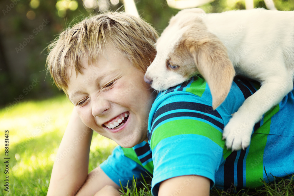 Child lovingly embraces his pet dog Child lovingly embraces his pet dog