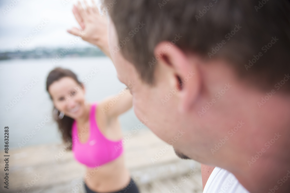 Fototapeta premium Sport woman and man jogging on road outside.