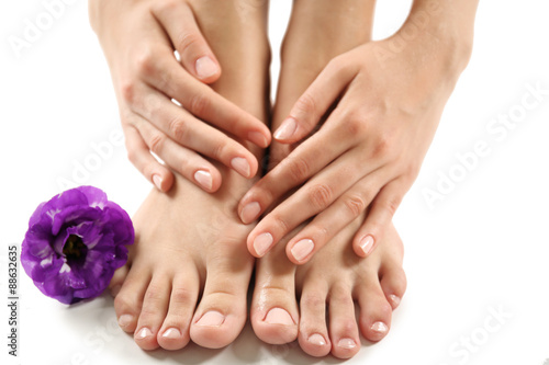 Female feet at spa pedicure procedure with flower isolated on white © Africa Studio