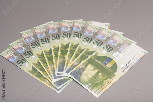 50 Swiss Franc bills isolated on gray background