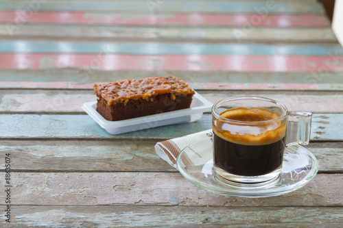 Coffee cup and cake on old wooden table for breakfast photo