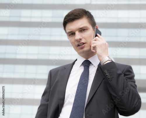 Portrait of an handsome young businessman in an urban setting