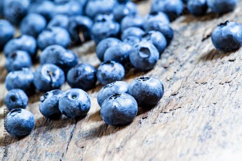 Fresh blueberries on old wooden background selective focus