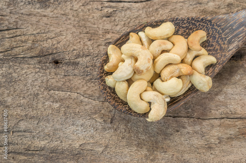 Roasted cashews on natural wooden background