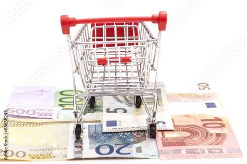 shopping cart on euro banknotes isolated